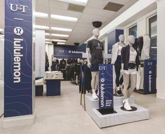 Photo inside a store with a lululemon banner and UofT clothing on mannequins