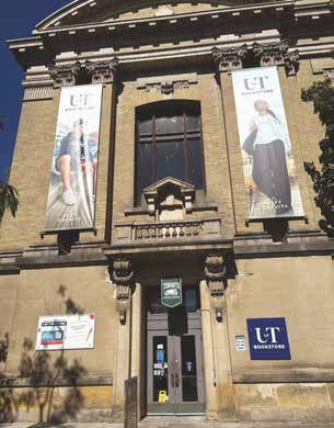 Photo of a two-storey building with UofT signs and banners
