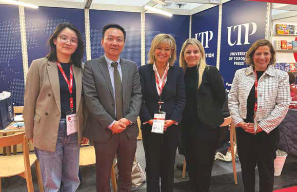 Photo of five people standing in front of a UTP booth.